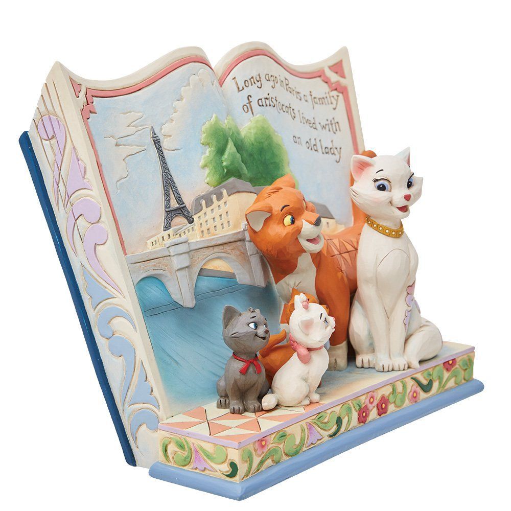 Disney Aristocats-figuurtje in een boeksetting met de Eiffeltoren en katten.