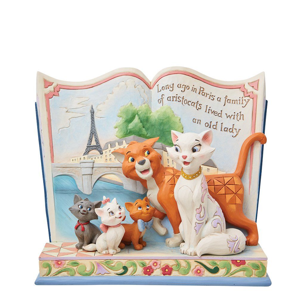 Standbeeld van de familie Aristocats voor een Parijs tafereel; katten in levendige kleuren, omlijsting in de vorm van een boek.