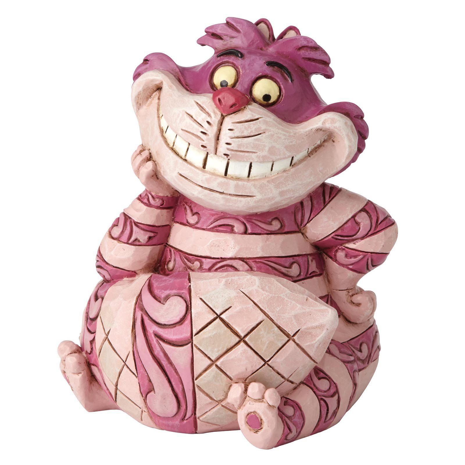 Een beeldje van de Cheshire Cat, roze gestreept en grijnzend, met zijn kop rustend op een hand.