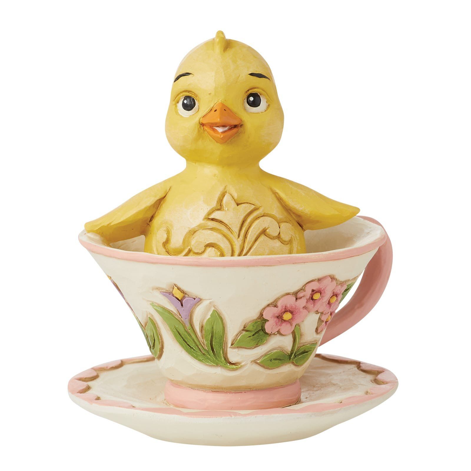 Een geel kuikentje in een theekopje met bloemenprint.