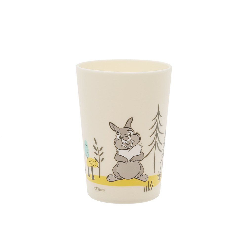 Beige kopje met een afbeelding van een lezend konijn in een boslandschap.