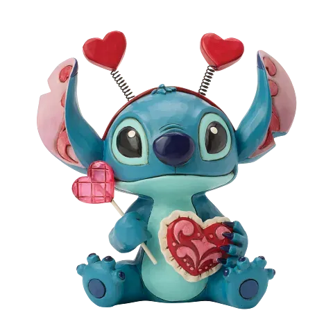 Een Stitch-figuurtje met een hartje in zijn hand en hartvormige antennes, in blauw, roze en rood, met een Valentijnsdagthema.