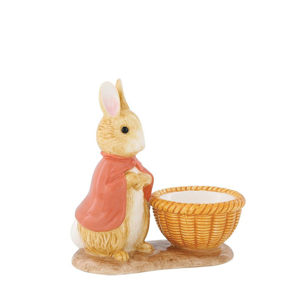 Peter Rabbit-figuurtje met een mandje. Het konijn draagt een rode cape en staat naast een gevlochten mandje.
