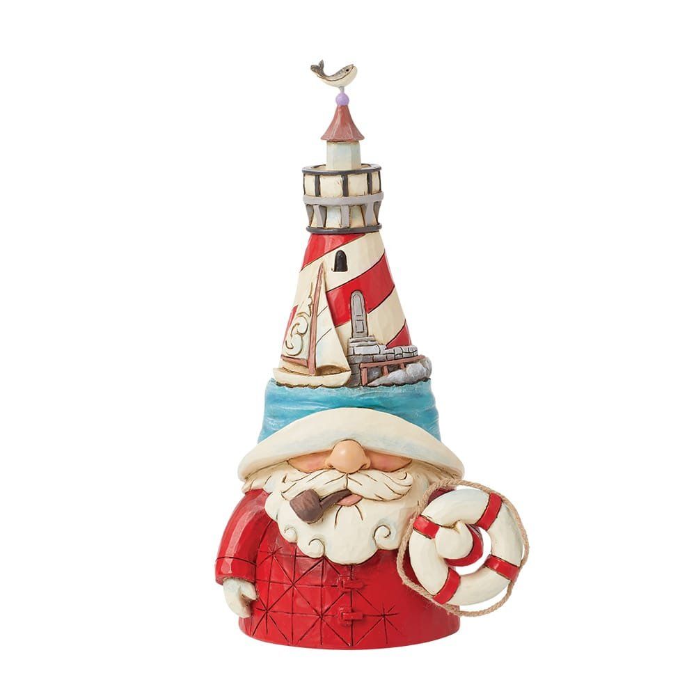 Een kerstmanfiguur met een vuurtorenlichaam, die een reddingsboei vasthoudt.