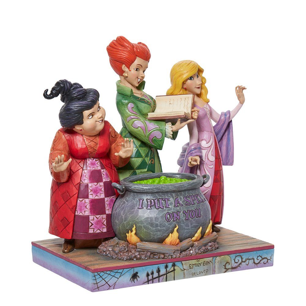 De Sanderson-zussen uit Hocus Pocus zaten rond een borrelende ketel en lazen een toverboek.