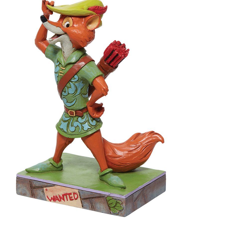Robin Hood-beeldje, een oranje vos met een strik, gekleed in een groene tuniek en hoed, op een sokkel met een 