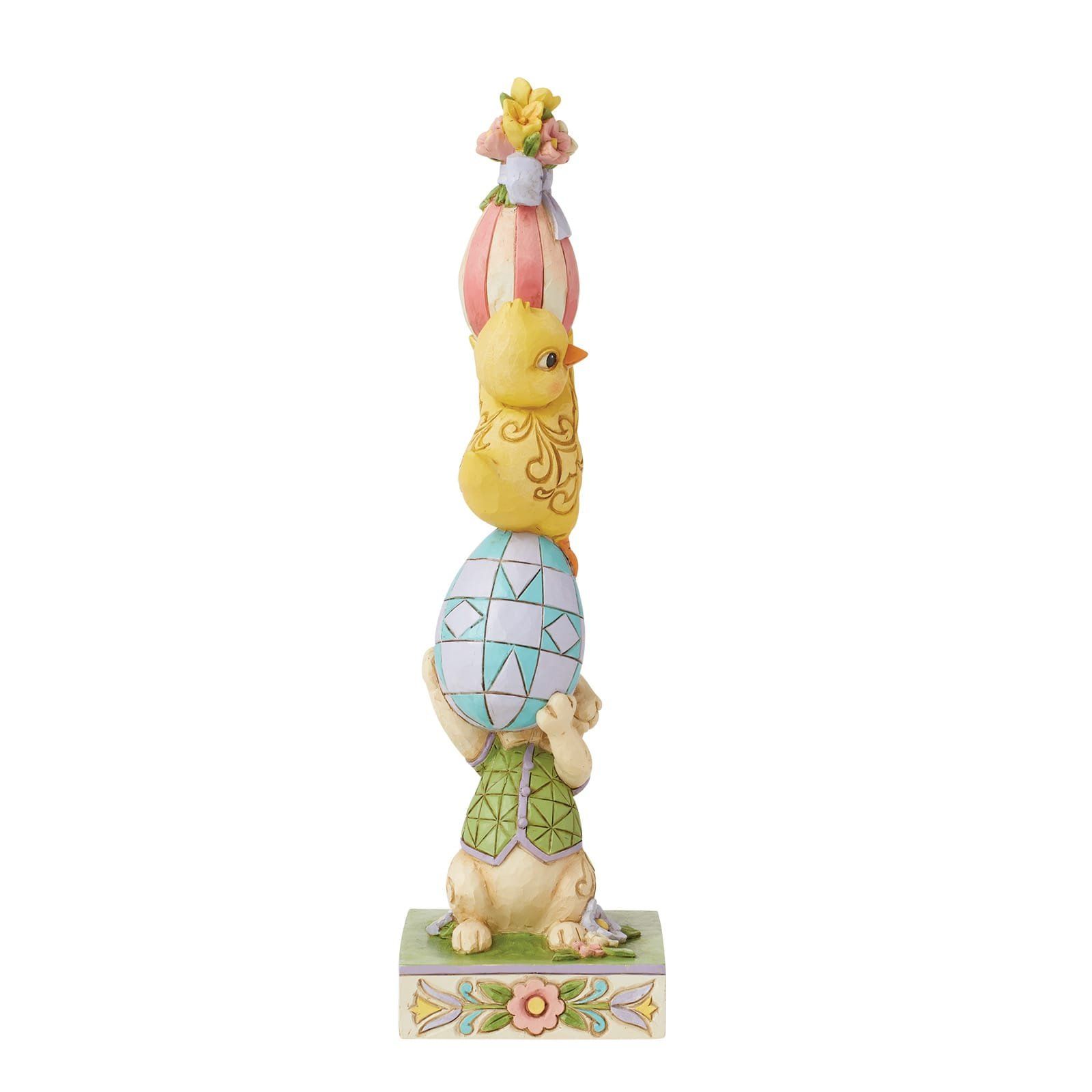 Paasfiguurtje: konijntje met blauw ei, kuikentje, gestreept ei, met bloem erop, staand op een bloemvormige voet.