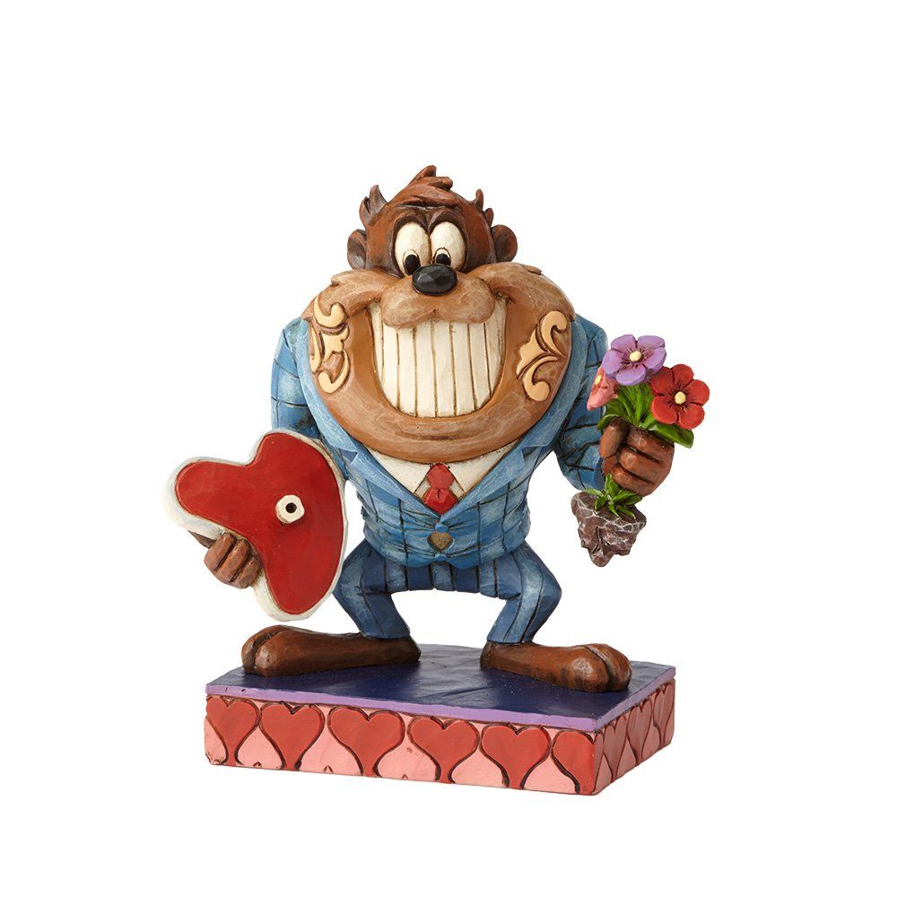 Een beeldje van de Tasmaanse duivel, met een biefstuk en bloemen in zijn handen, in pak en lachend op een platform met een hartvormig thema.