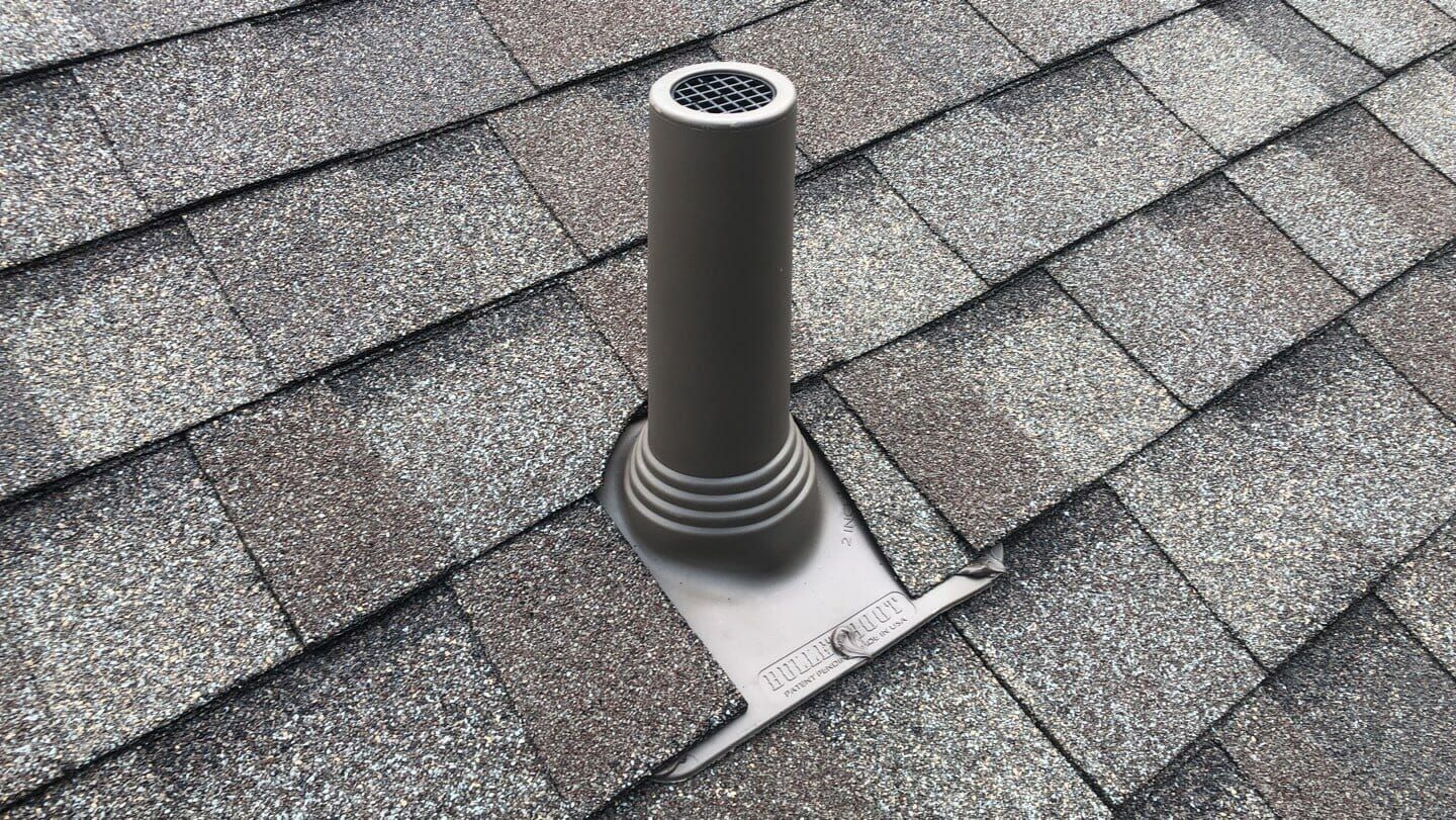 A pipe is sitting on top of a roof.