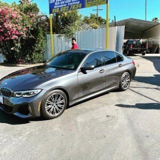 Client New Black Car — Sacramento, CA — Low Cost Auto Glass & Window Tinting