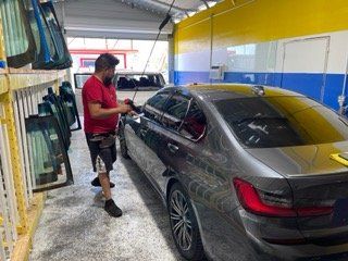 Man Cleaned a Small Car — Sacramento, CA — Low Cost Auto Glass & Window Tinting