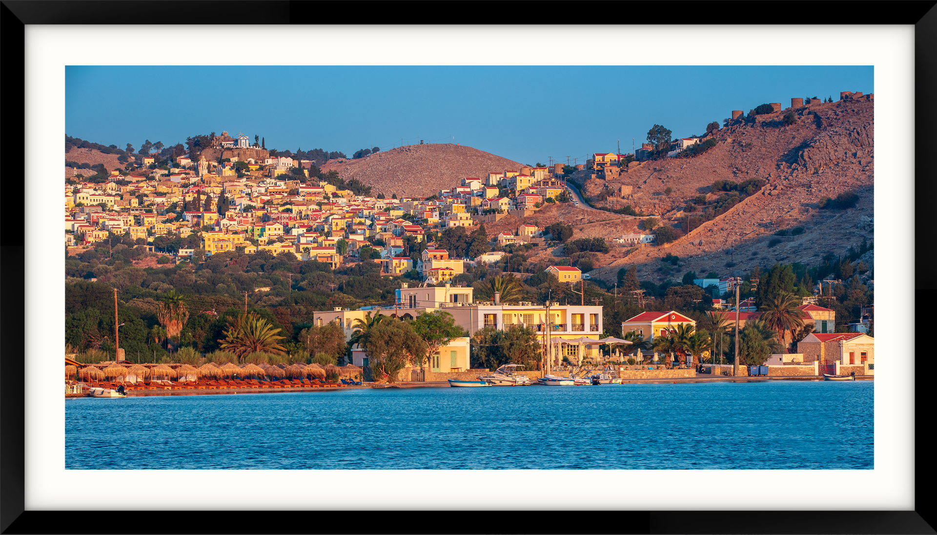 Greece - Symi Island a picture of a lake with mountains in the background