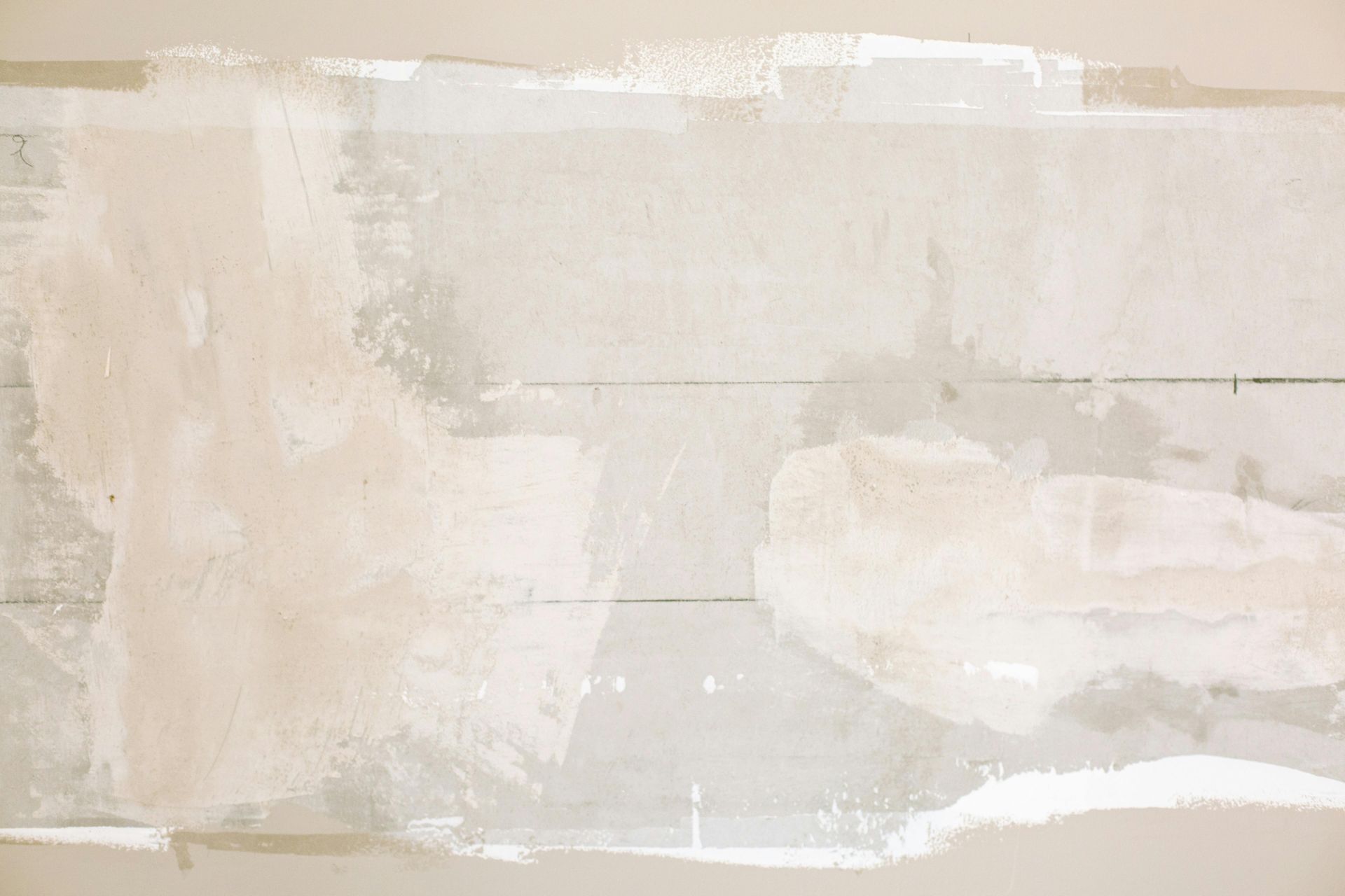 Textured white surface with visible brushstrokes and partially covered wooden boards.