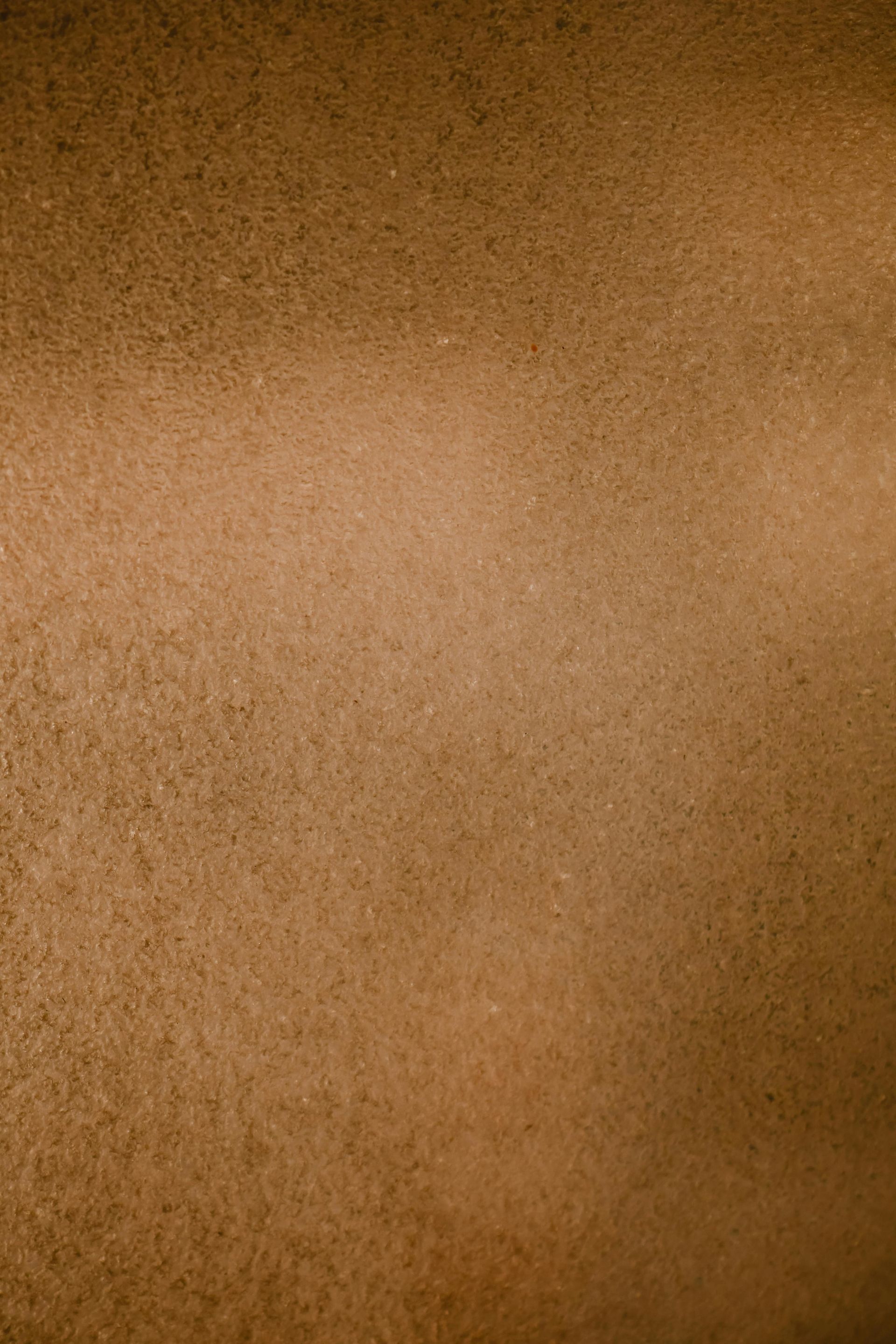Brown, textured surface with a slightly lighter horizontal band across the middle.