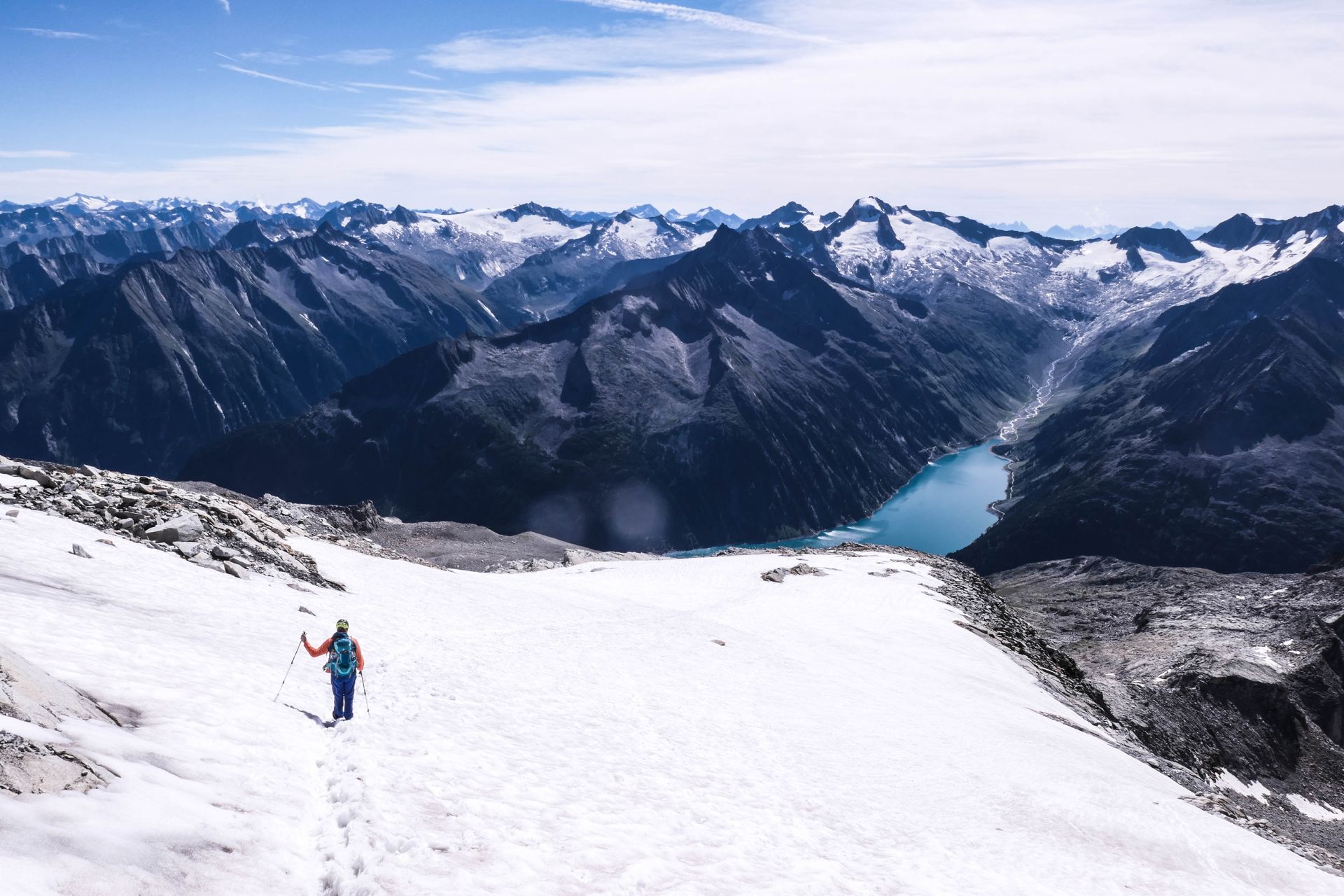 A hiker far above Lake Schlegeisspeicher, Zillertal, Austria