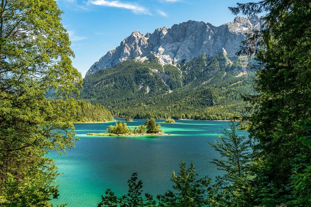 Turquoise Lake Eibsee with wooded shore, small islands, and the Zugspitze in the background 