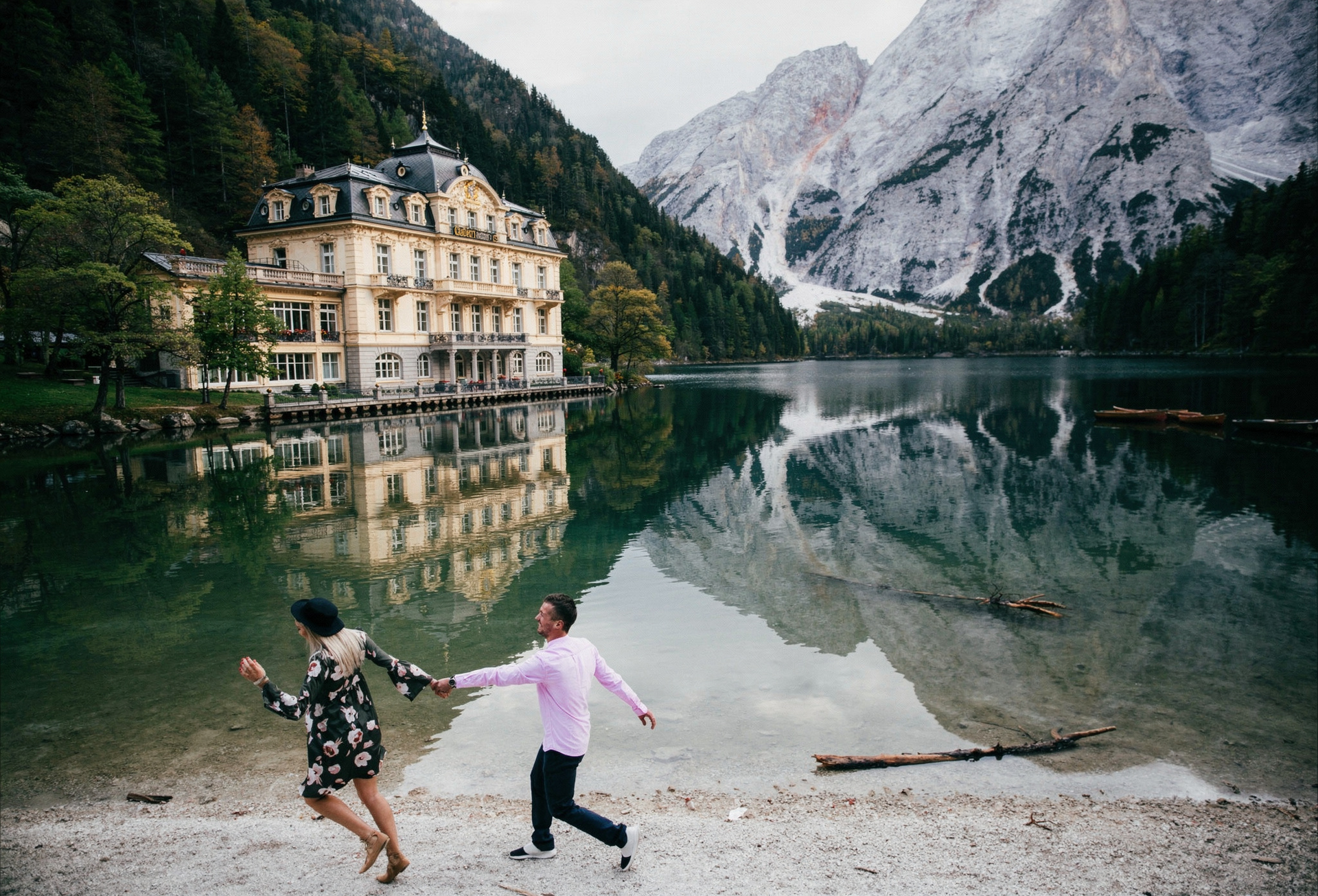 Romantic couple enjoying a private alpine lake escape surrounded by mountain scenery