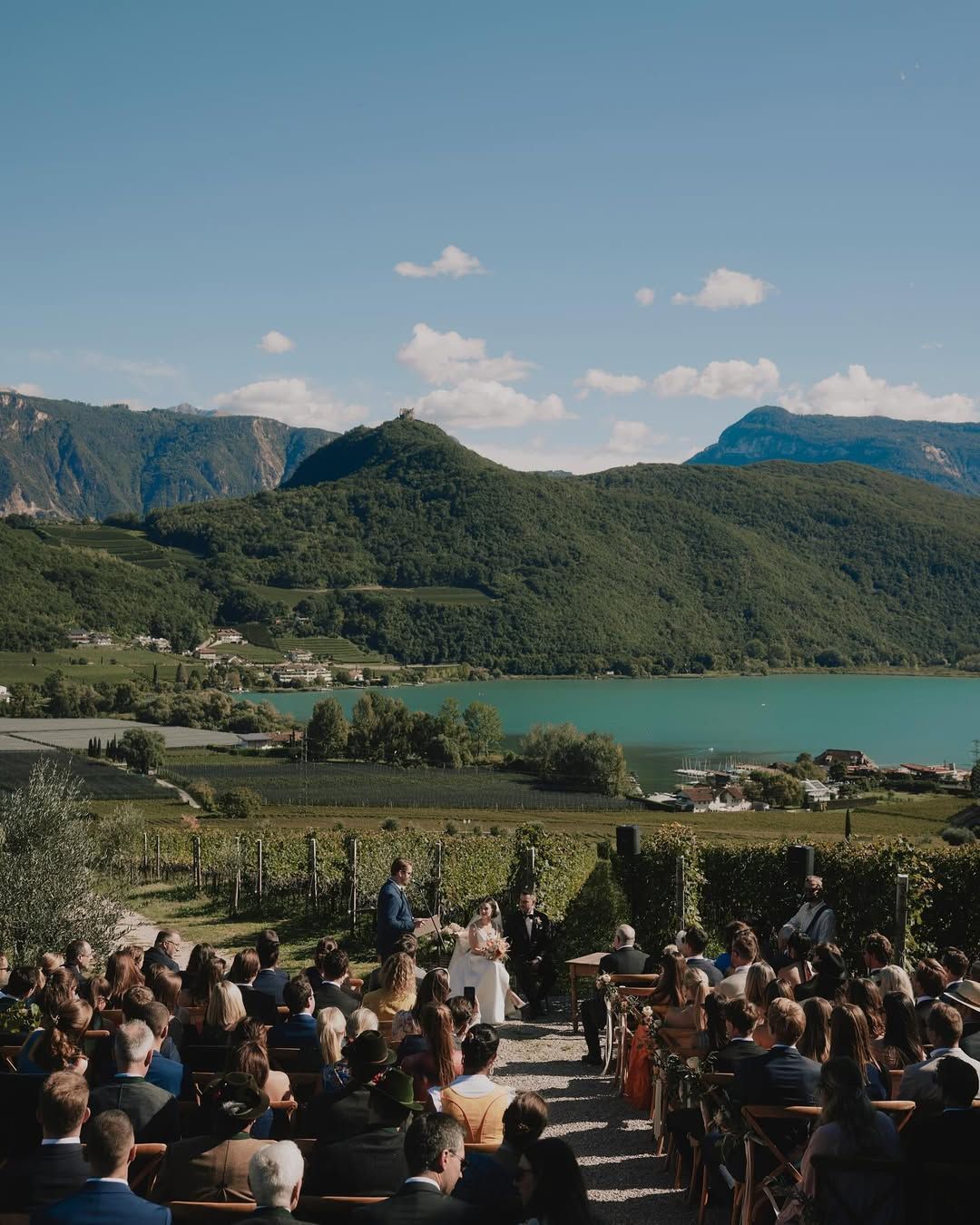 Elegant destination wedding celebration overlooking an alpine lake in South Tyrol