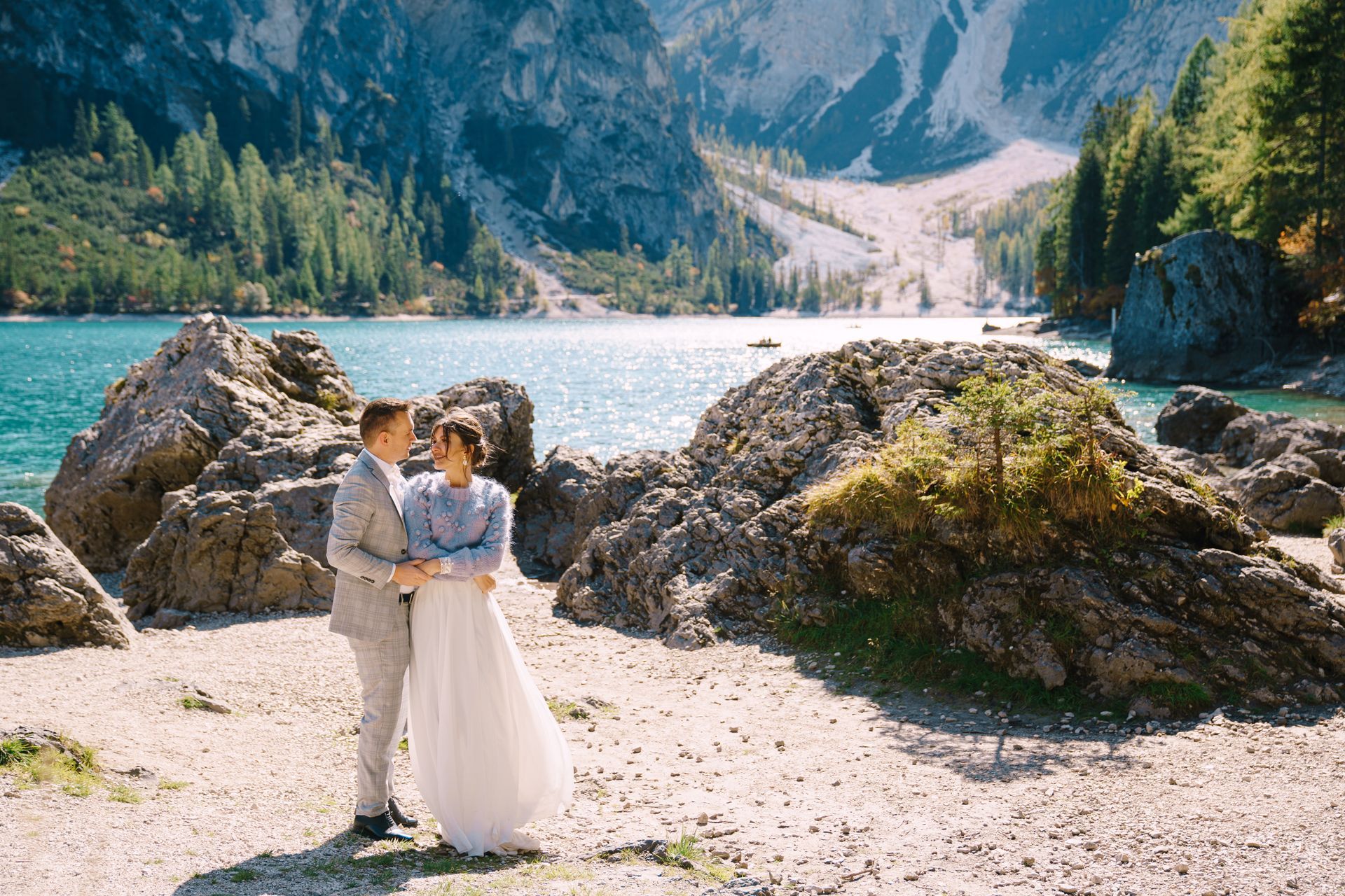 Romantic destination wedding couple by an alpine lake in the Dolomites