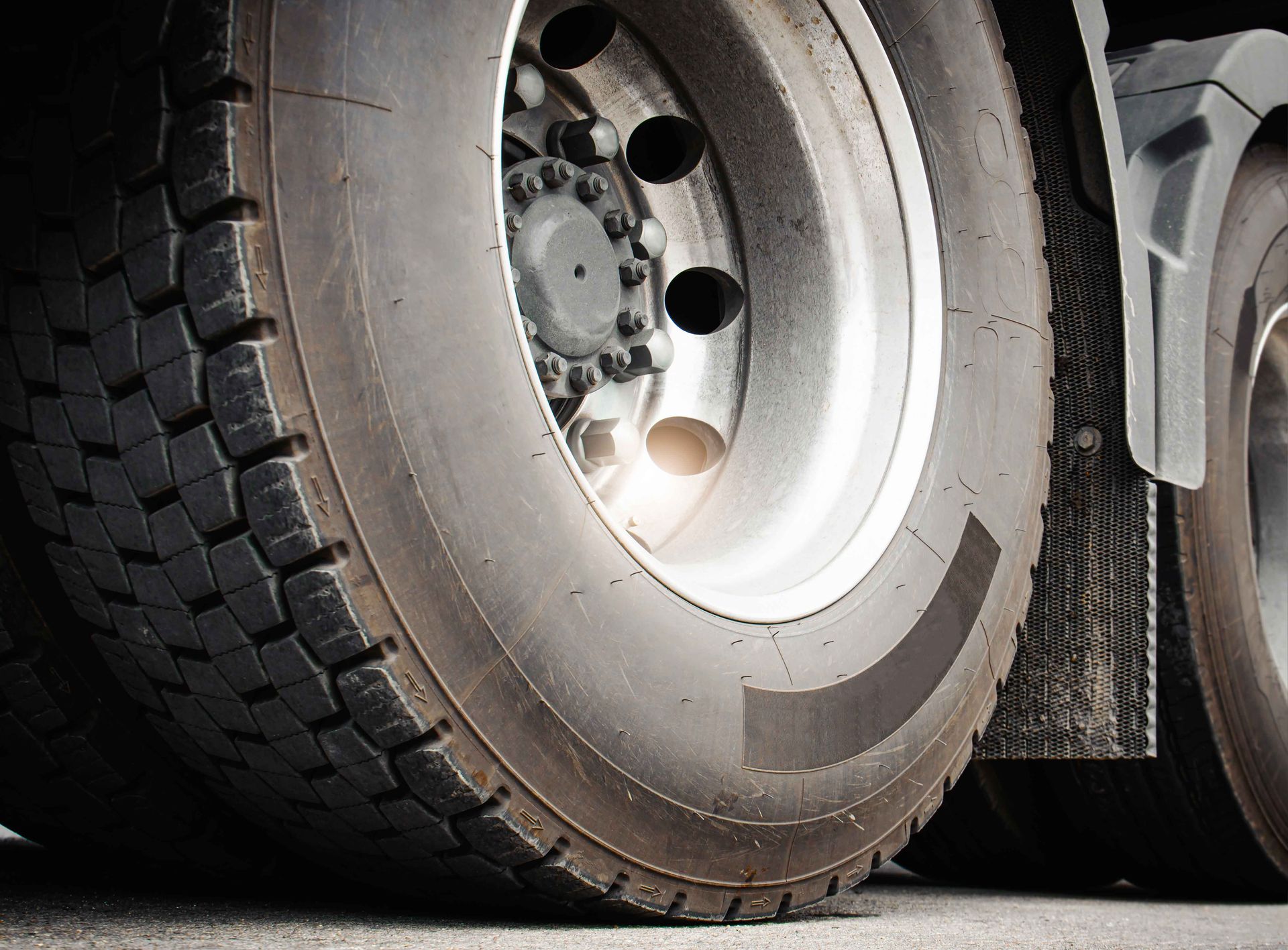 A close up of a truck tire on a road