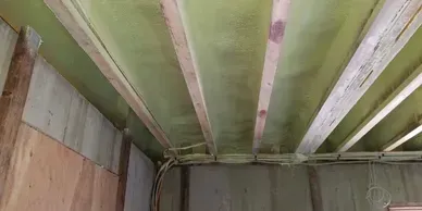 a room with a green ceiling and wooden beams .