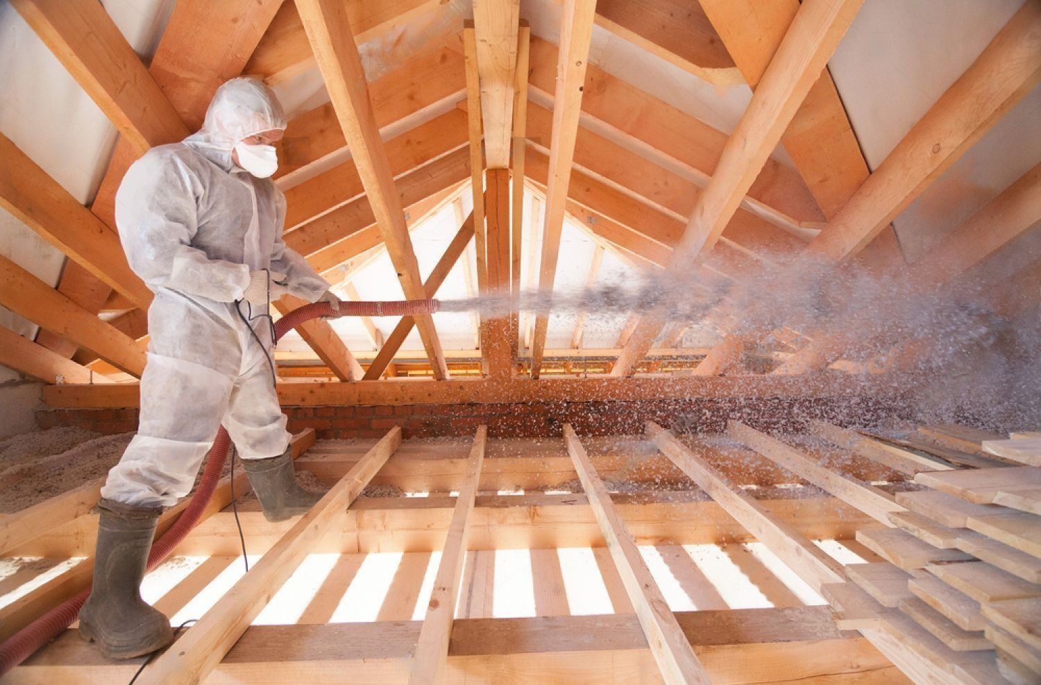 man spraying ecowool insulation