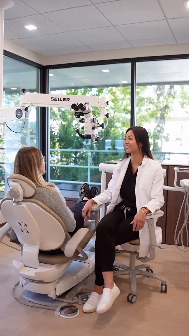 Bright dental exam room with chair, X-ray screen, stool, and large windows