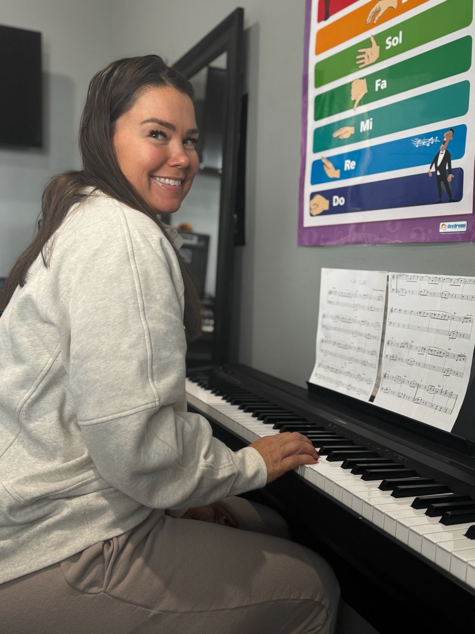 Woman Looking To A Keyboard Piano — Carmel, IN — Carmel Music Academy Woman Looking To A Keyboard Piano — Carmel, IN — Carmel Music Academy