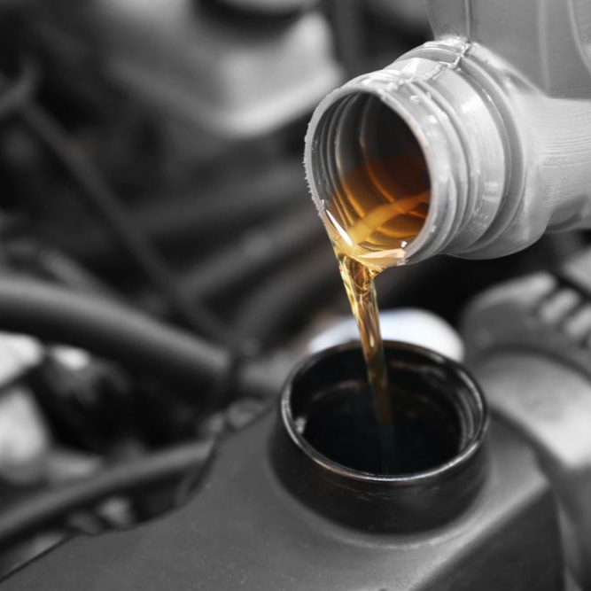 Oil Being Poured From a Bottle Into a Car Engine — Alice Springs Auto Parts in Ciccone, NT