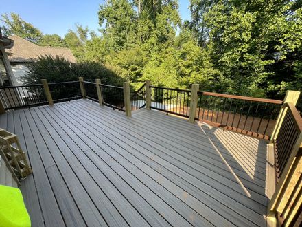 Finished composite decking with black balusters and wood railing in Lawrenceville