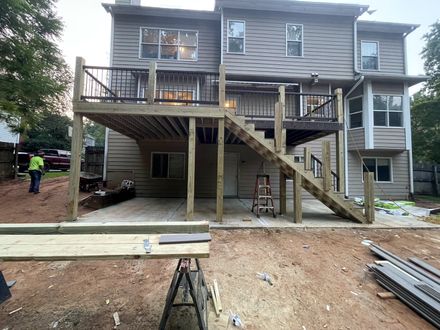 Deck rebuild in progress showing framing and stairs
