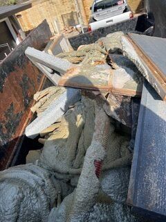 Dumpster filled with concrete debris, possibly from construction or demolition.