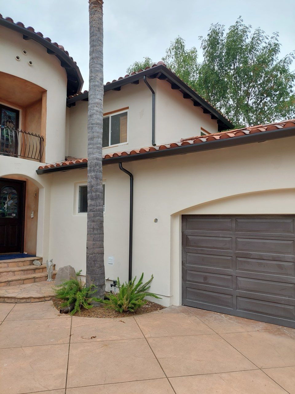 stucco home tile roof gutters