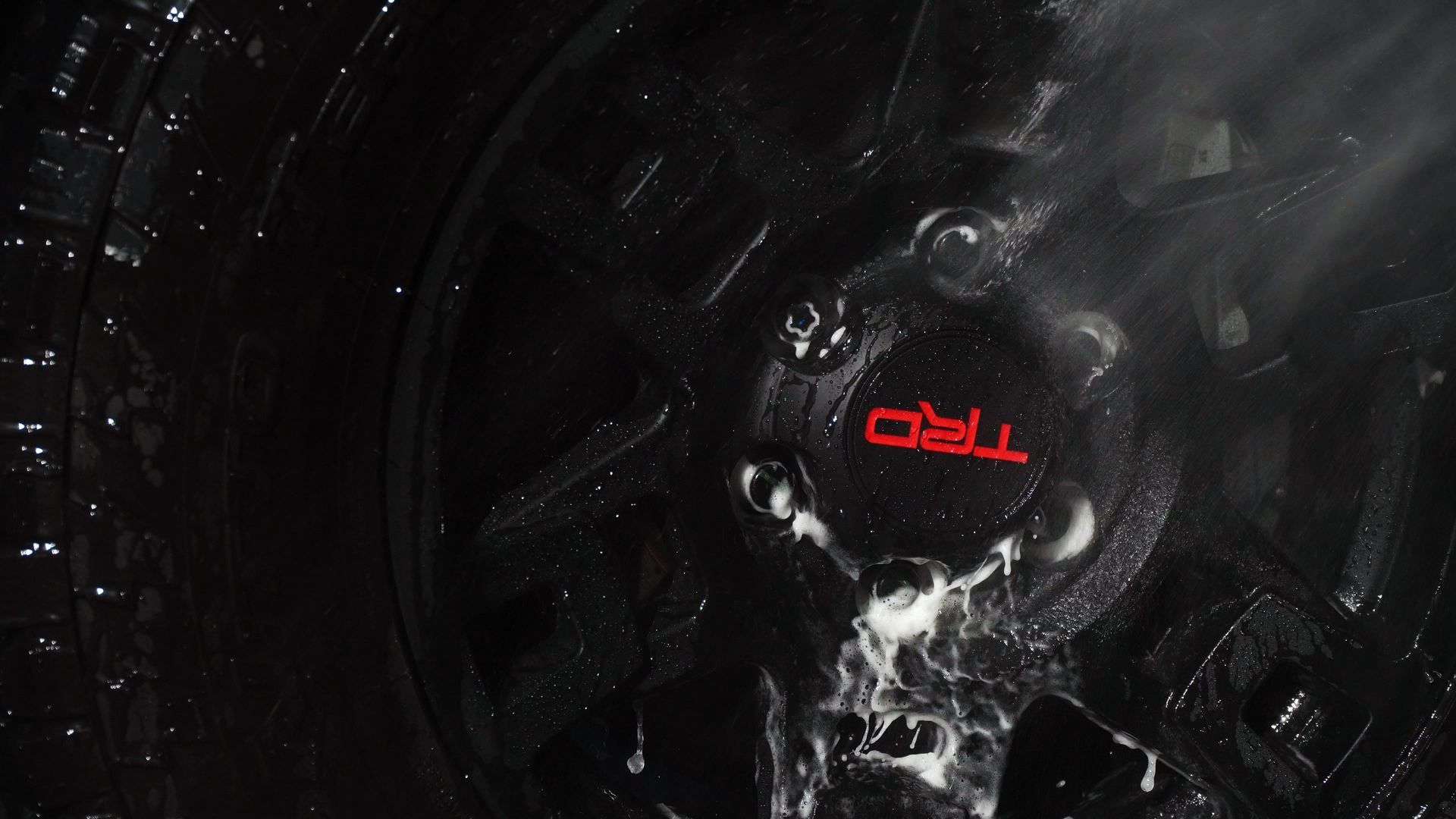 Red TUF logo glowing on a dark, abstract mechanical background.