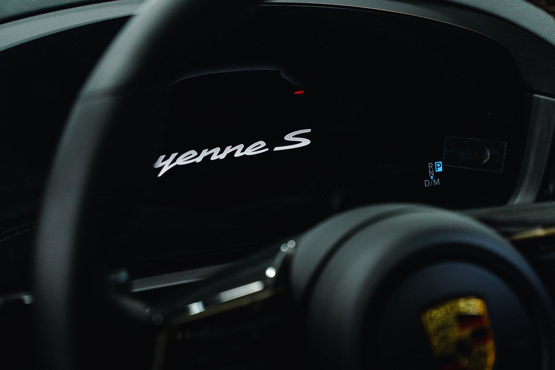 Porsche Taycan dashboard displaying “yenne S” in white text on a dark instrument cluster
