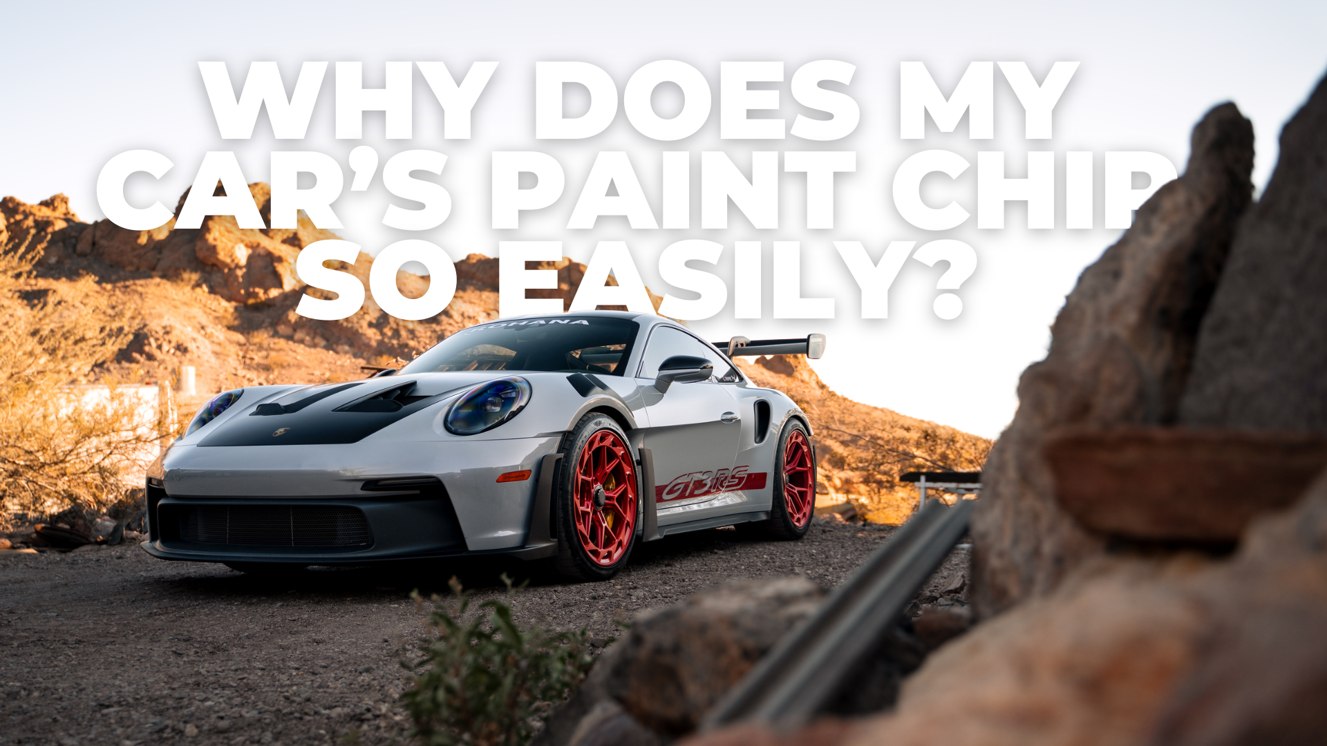 White sports car on rocky road with explosion background and text: “Why does my car’s paint chip so easily?”