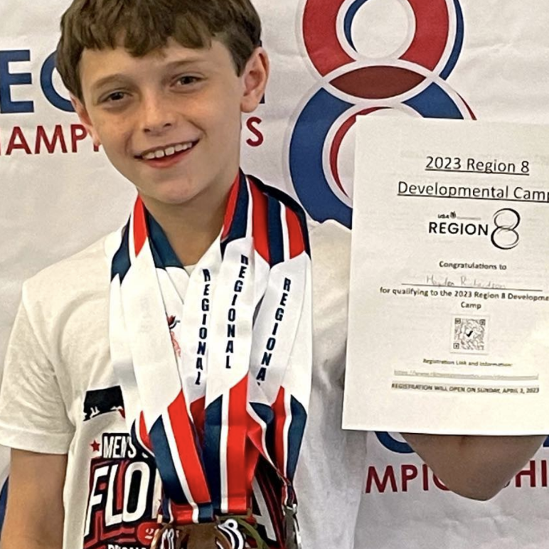 gymnasts posing with awards