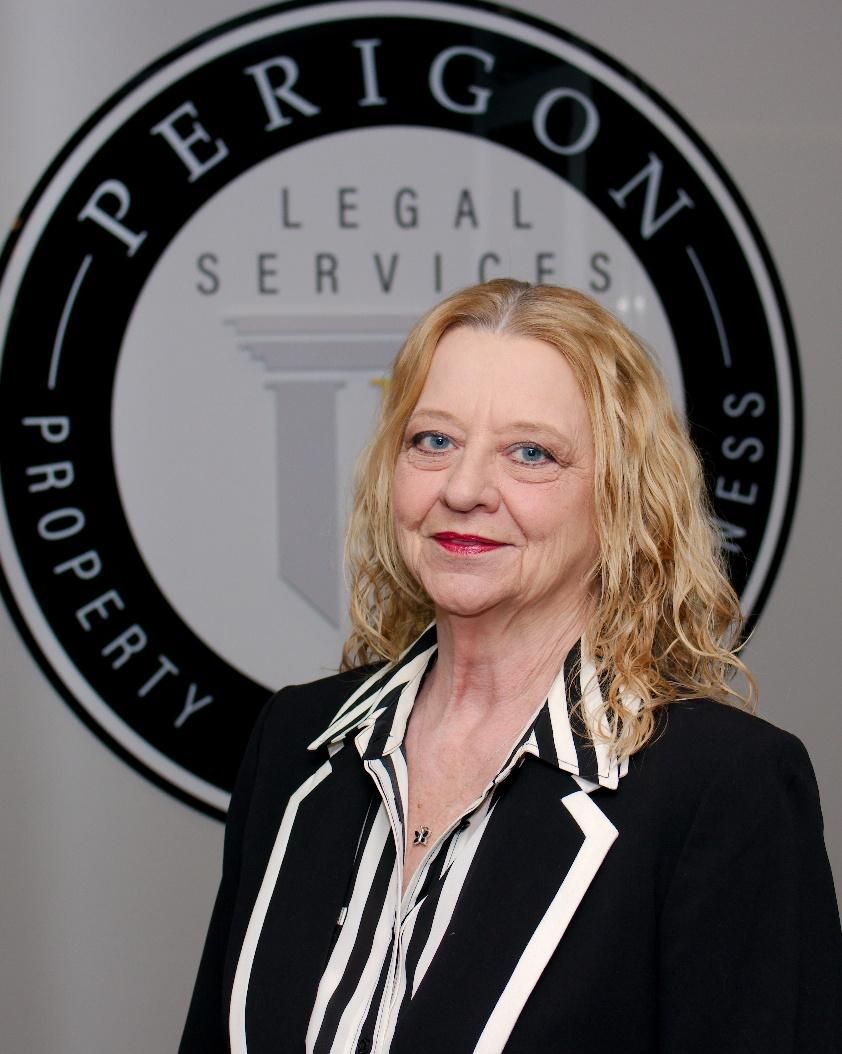 Woman in black blazer with white trim standing before a Legal Services Property sign