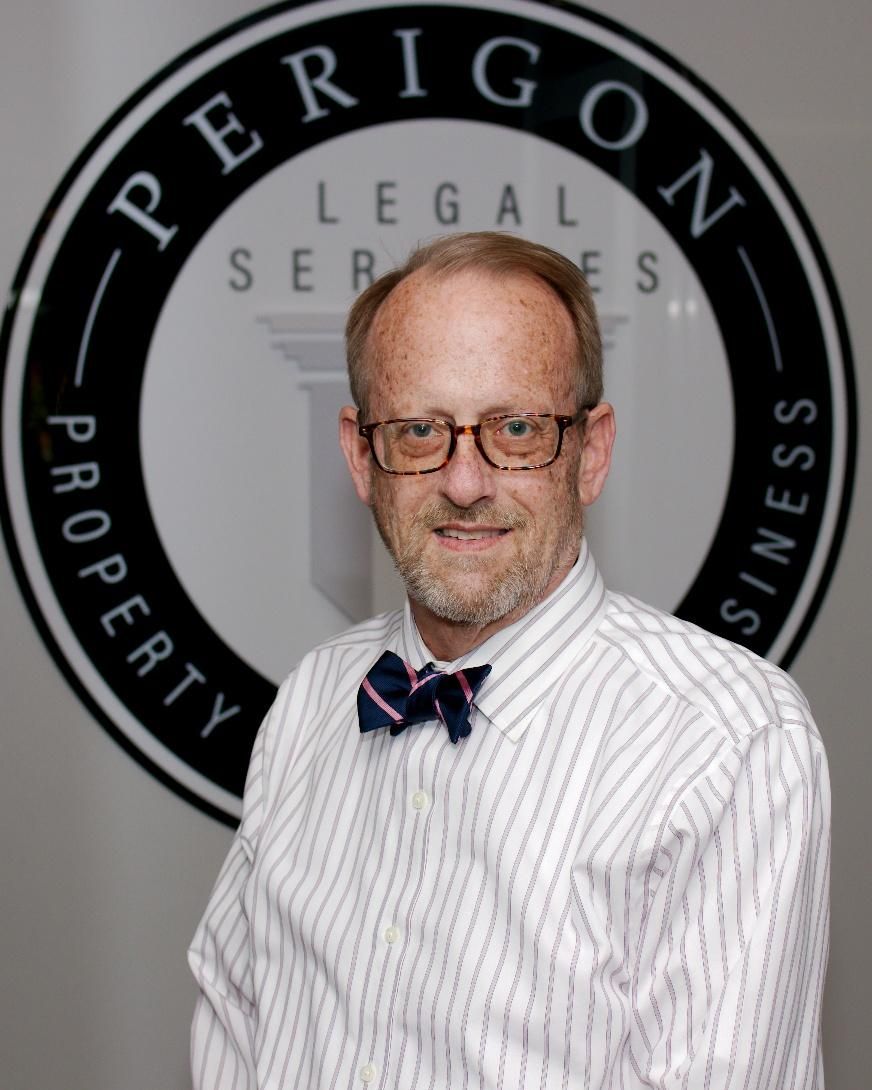 Man in striped shirt and bow tie standing before an Eperigon Legal Services logo backdrop