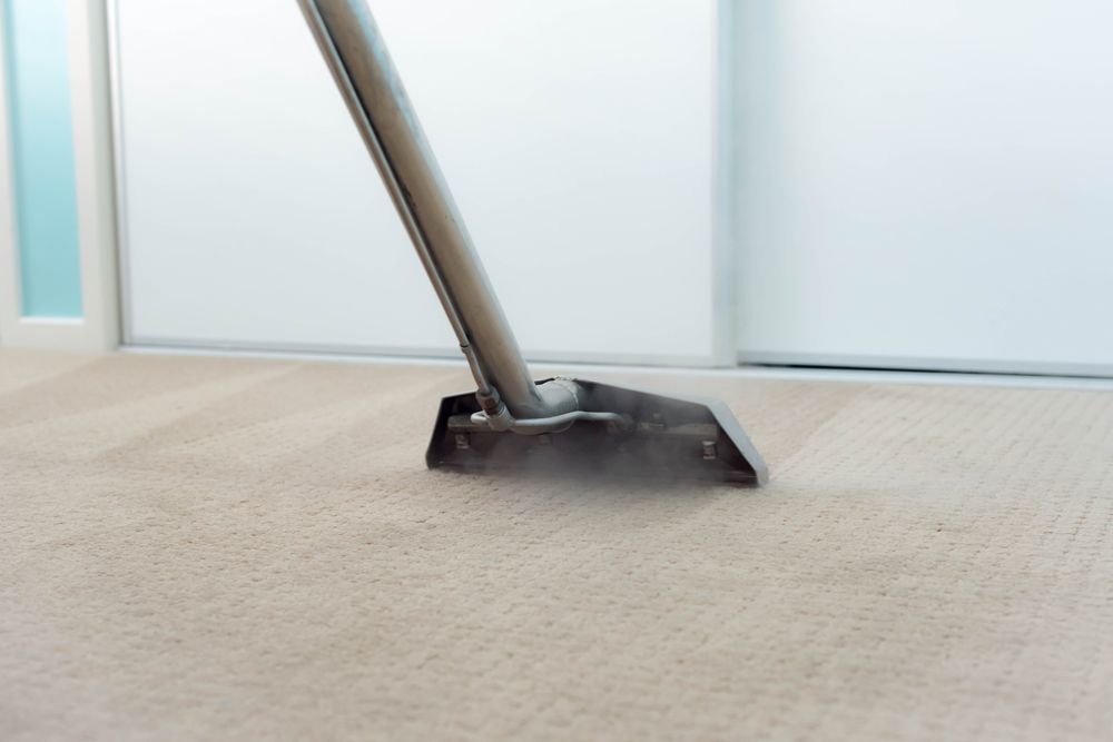 A Person is Cleaning a Tile Floor With a Toothbrush — Lease Clean Newcastle in Maitland, NSW