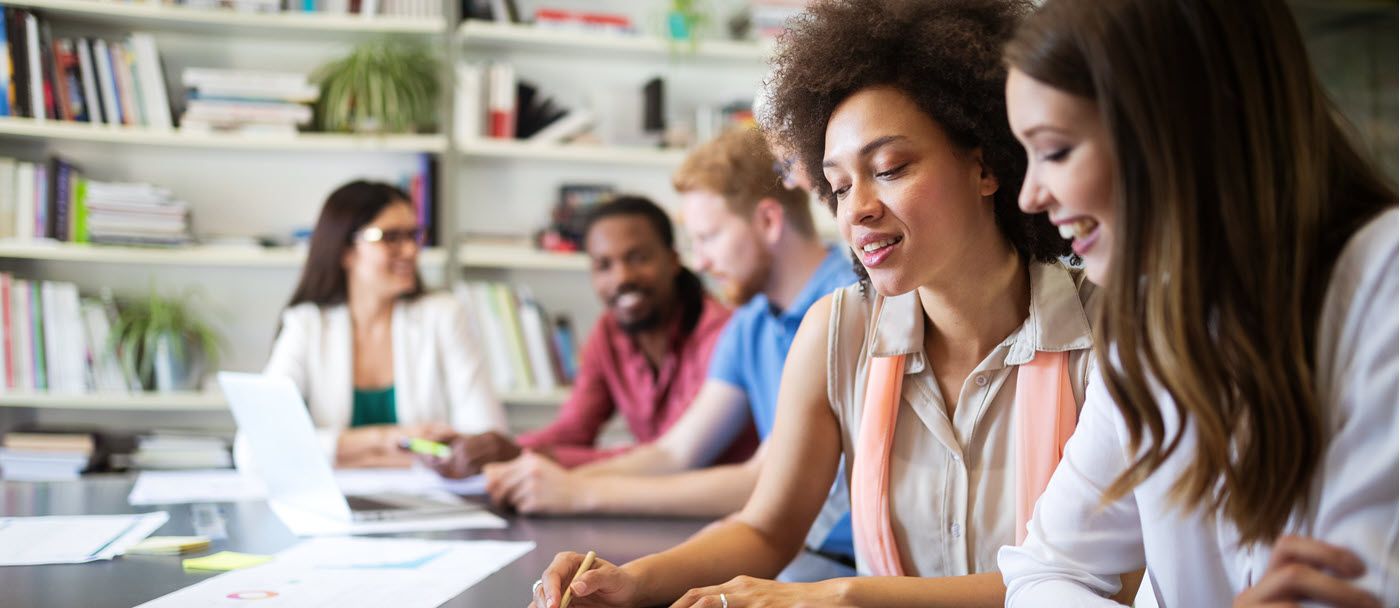 A Diverse Team of Men and Women Enjoy Sharing Information