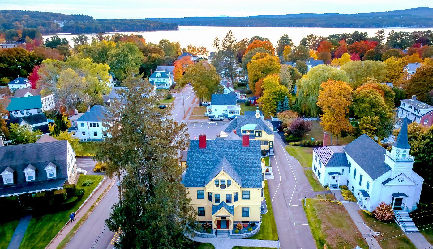 An aerial view of a residential neighborhood with a lake in the background.