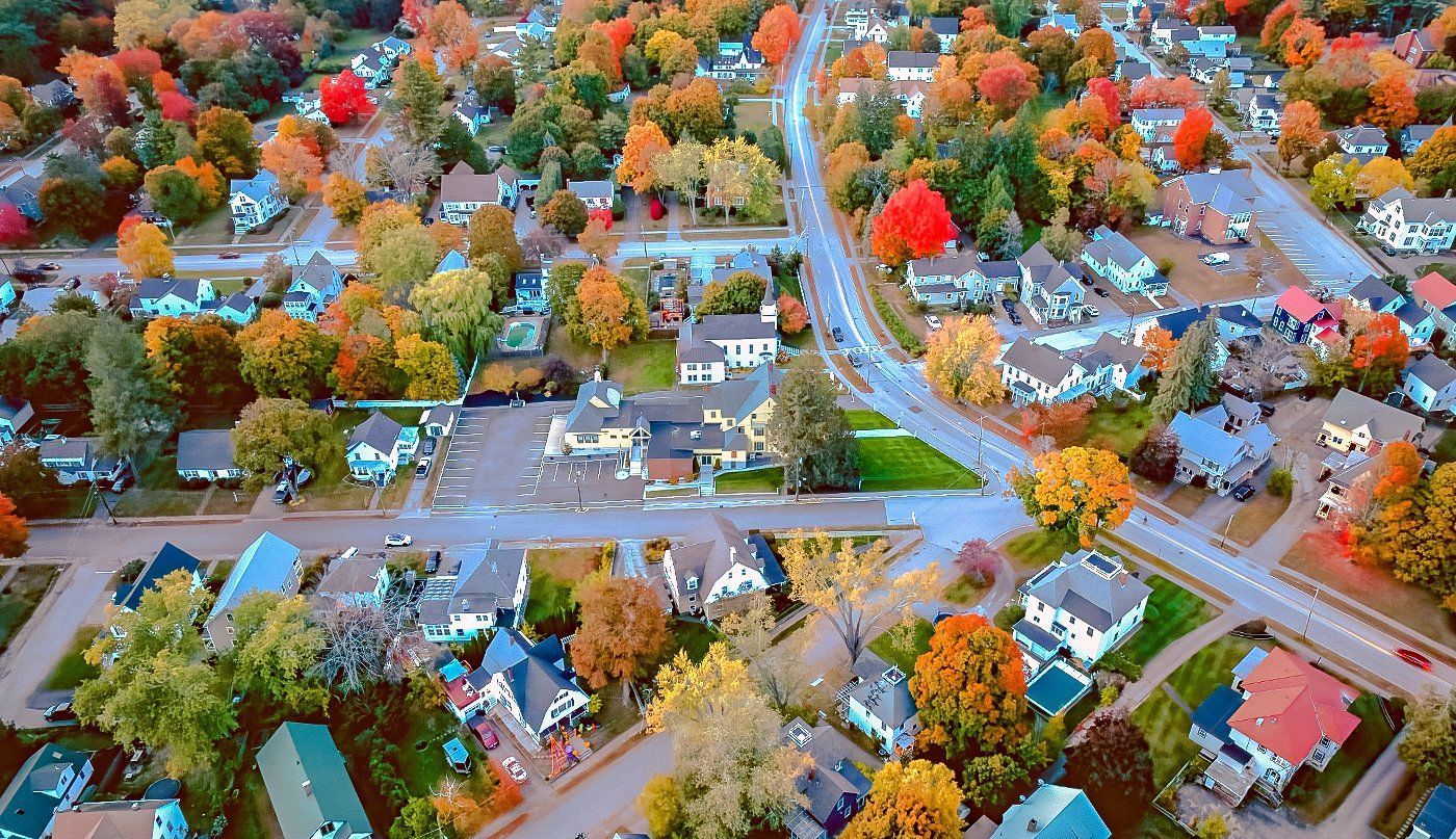 An aerial view of a residential area filled with lots of houses and trees.