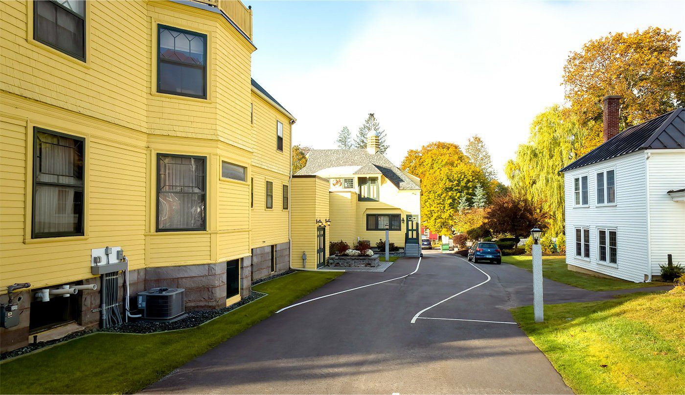 A row of yellow and white houses on a sunny day