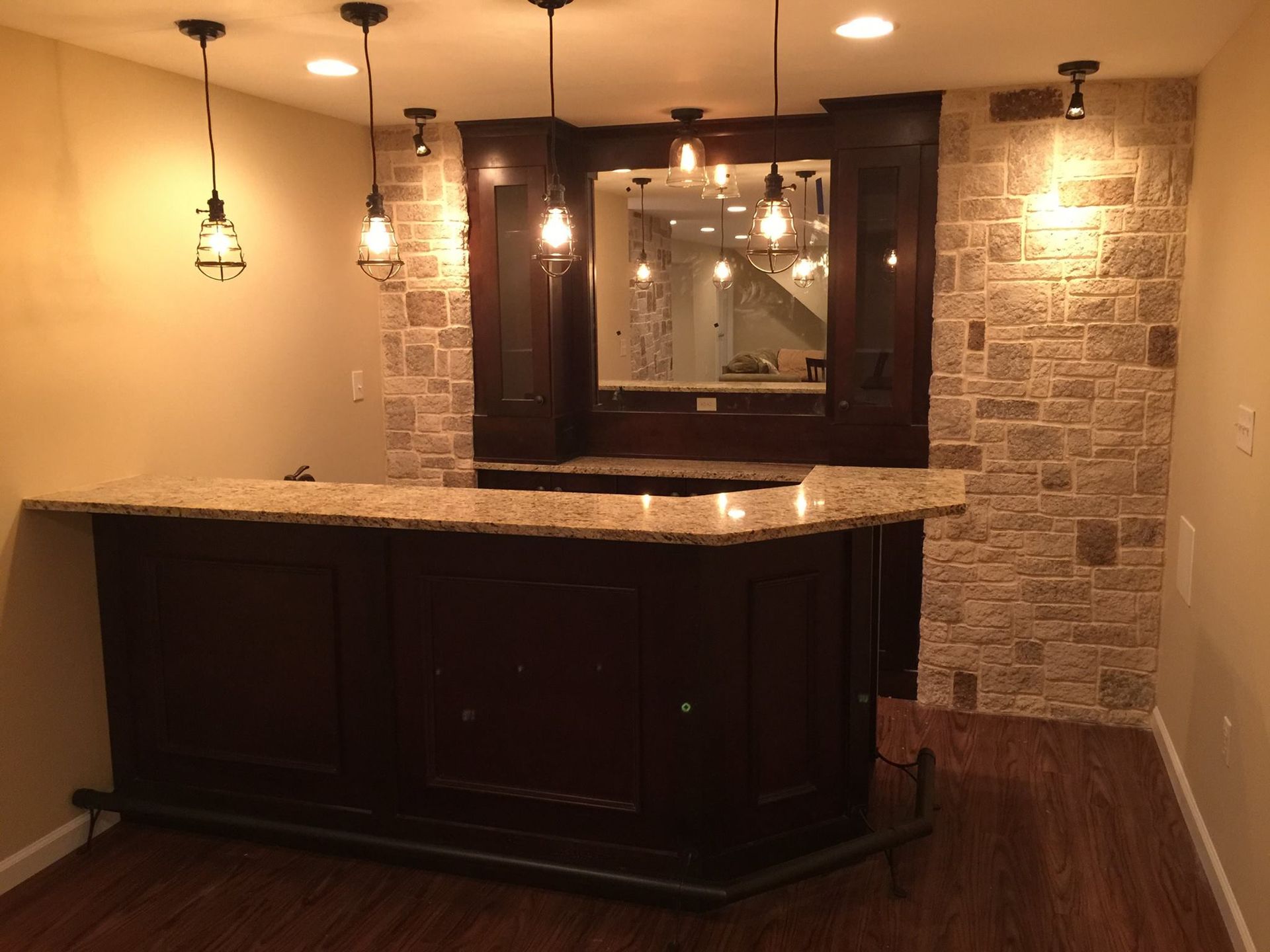 A basement with a bar and a stone wall