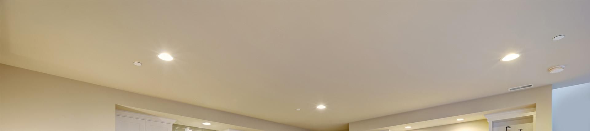 A white ceiling with a lot of lights on it in a room.