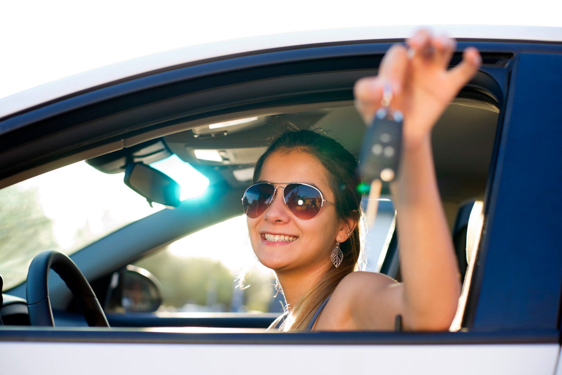 Head And Shoulders Shot Of A Teenage Girl Showing The Key — Flagstaff, AZ — Evans Insurance Inc.
