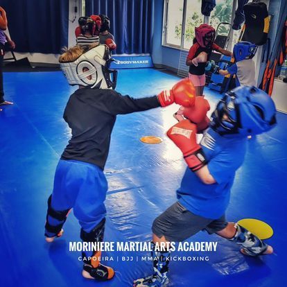 Two young boys are practicing martial arts at the moriniere martial arts academy