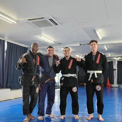 A group of men are posing for a picture in a gym.