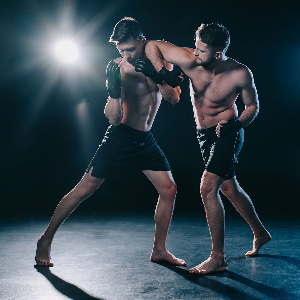 Two men are fighting each other in a boxing ring.